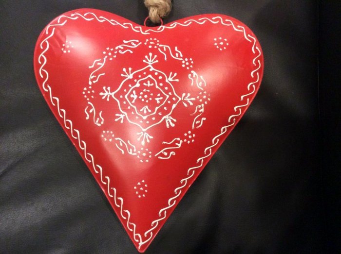 Coeur rouge bombé et décoré d'arabesques blancs, métal, 26x26x5 cm